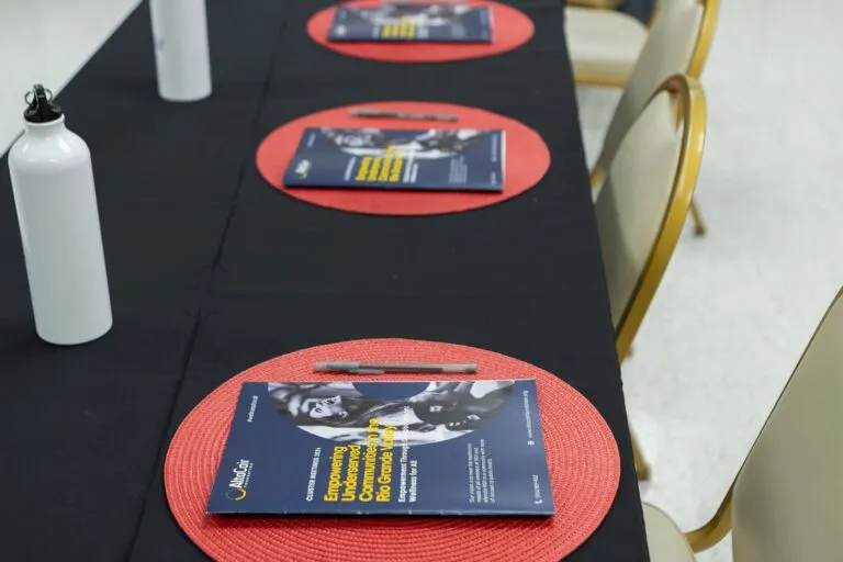 Meeting materials and AltaCair bottles are arranged at places around the table.