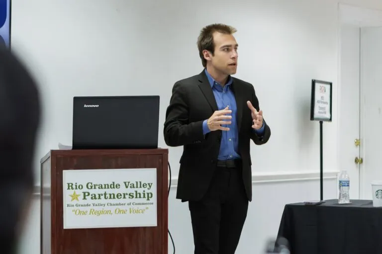 A speaker addresses the room from a Rio Grande Valley Partnership lectern.