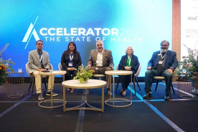 Speakers gather on stage for a panel discussion.