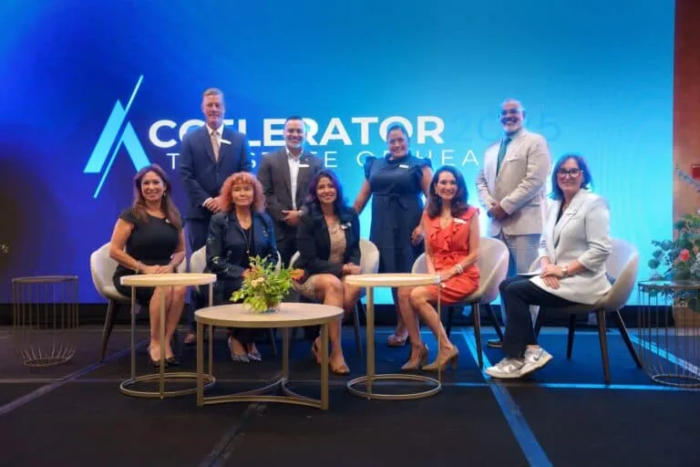 Panelists sit on stage beneath the Accelerator backdrop.